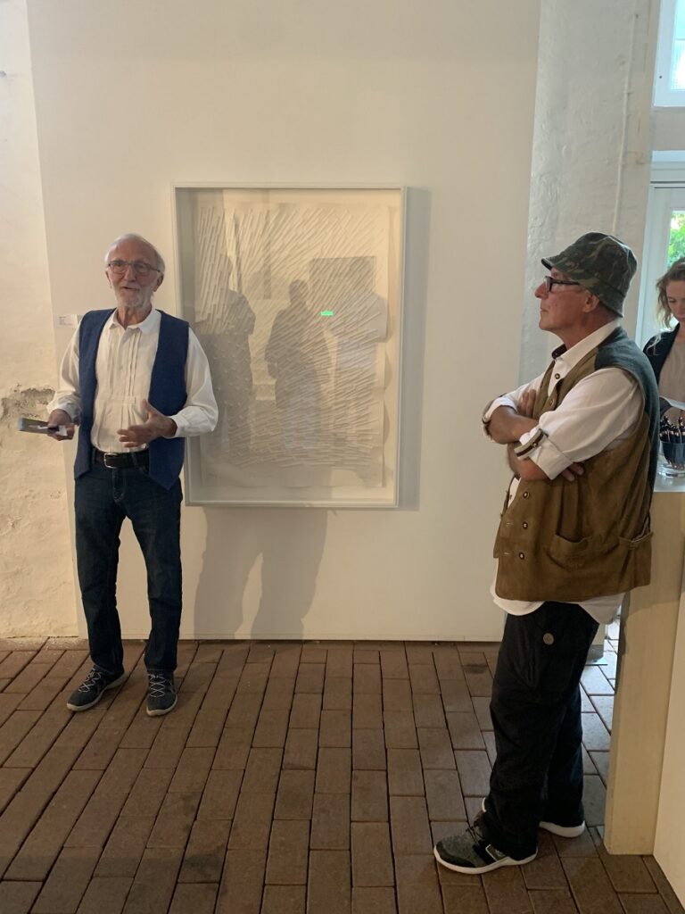 Kulturakteure vor einem Gemälde.